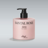 Pink lotion bottle with black pump labeled 'Santal Rose' on a gray OBJET BY KUNDAL Moist Gleam Body Wash in Santal Rose, 15.9 fl. oz. (470ml) pump bottle with Vitamin C & E and LHA/PHA.background