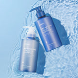 Two blue bottles of 'Airy Volume Hyaluron' shampoo and treatment on a water surface.
KUNDAL Airy Volume Hyaluron Shampoo and Treatment Duo, Blossom Breeze scent, 10.14 fl. oz. (300ml) bottles.