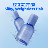 Kundal Airy Hydra Hyaluron Hair Serum bottles with water droplets on a light blue background